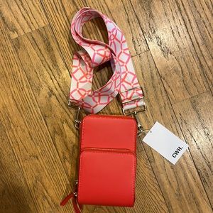 Small purse. Color is coral with a pretty strap that you can wear as a Crossbody